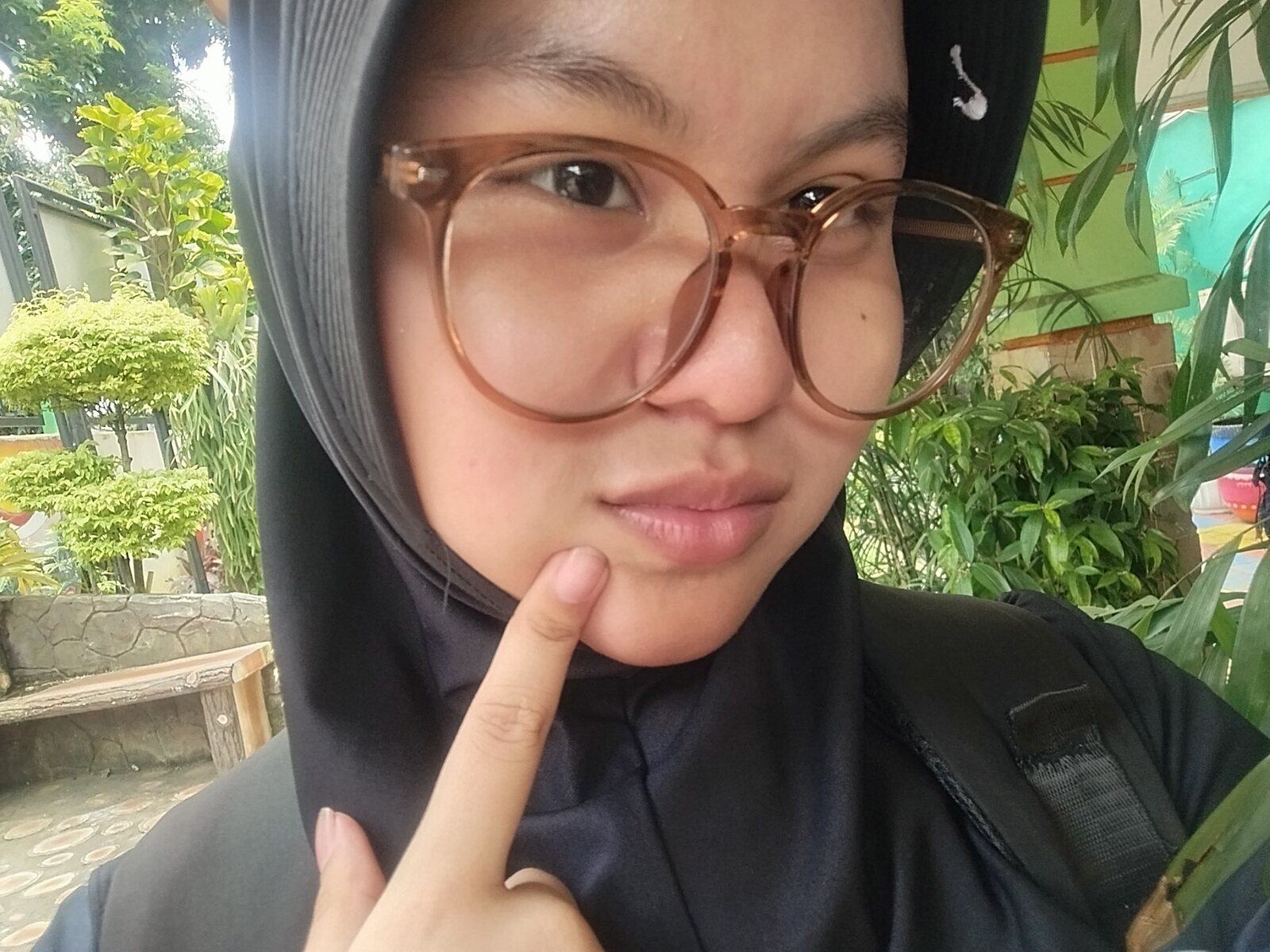 Nadhira posing with a finger on her cheek