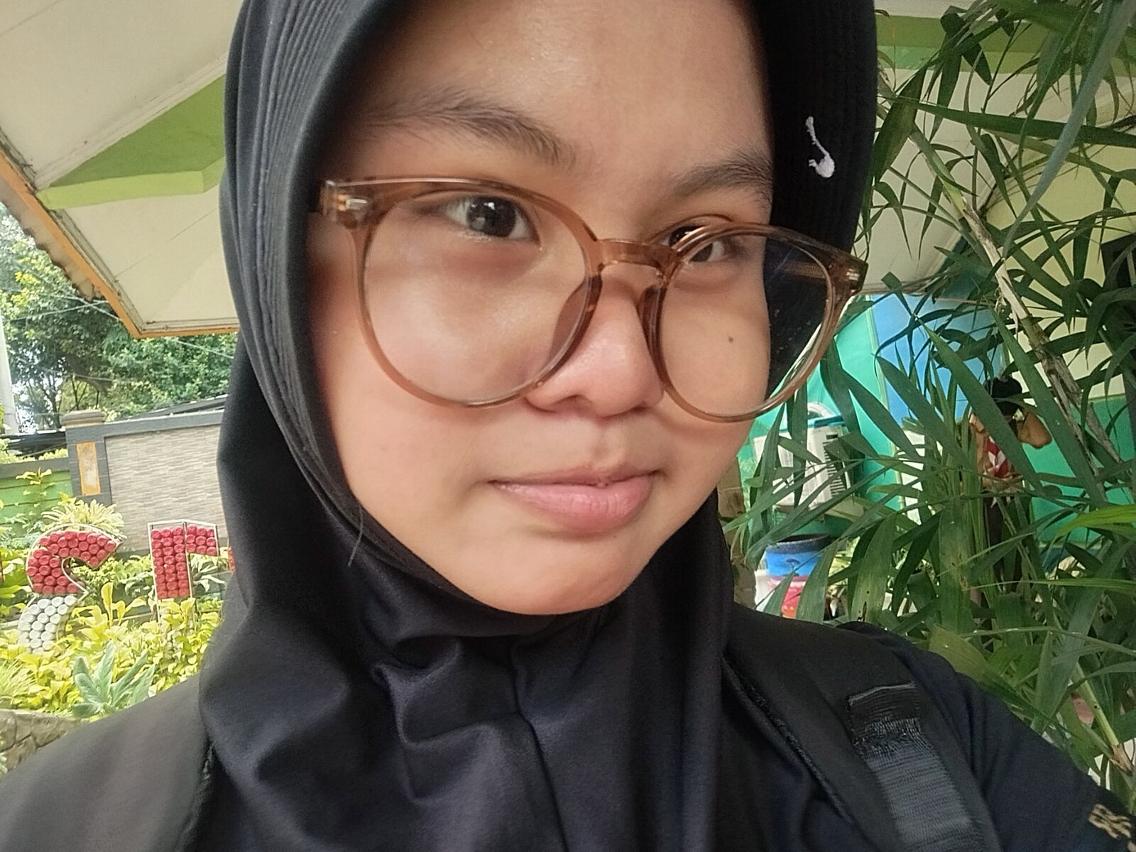 Close-up selfie of Nadhira smiling softly