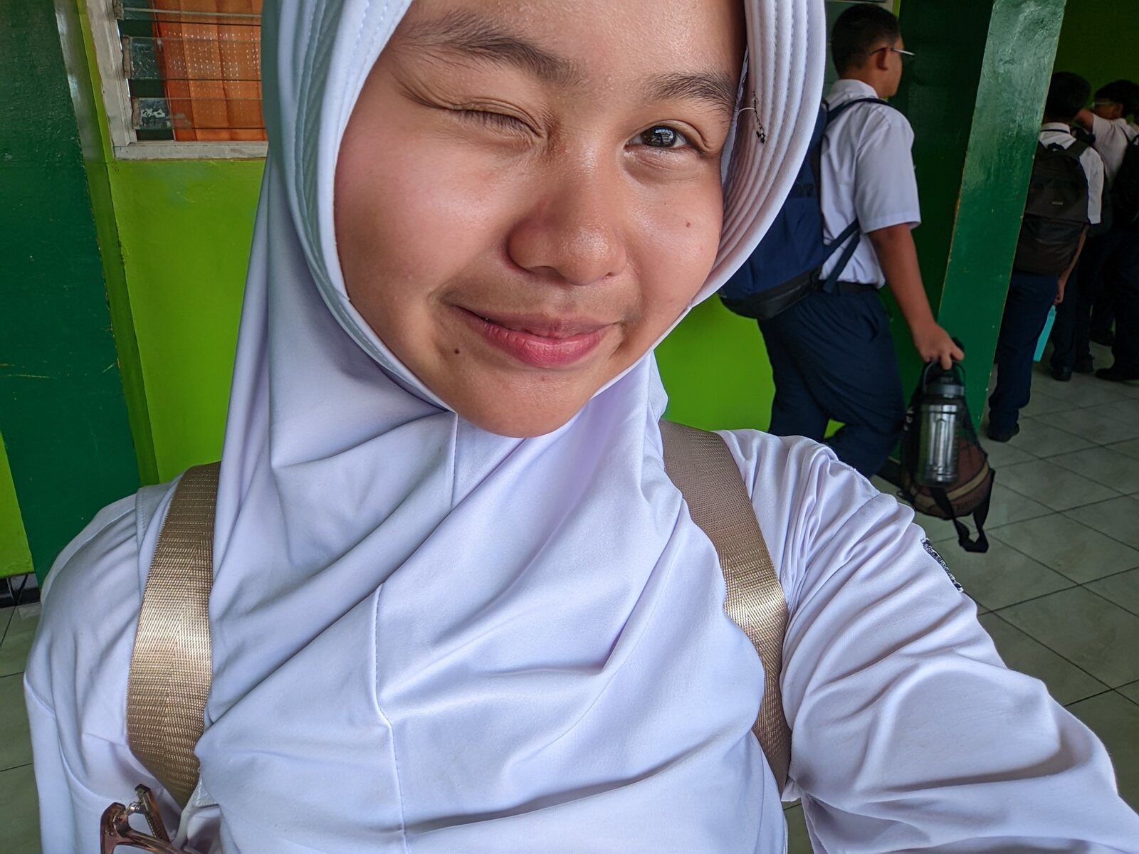 Nadhira taking a playful winking selfie