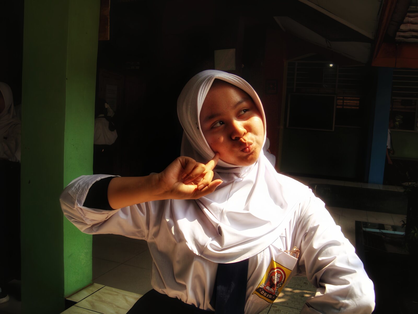 Nadhira posing playfully in warm sunlight